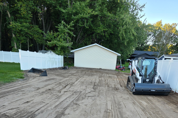 Land grading process with heavy machinery
