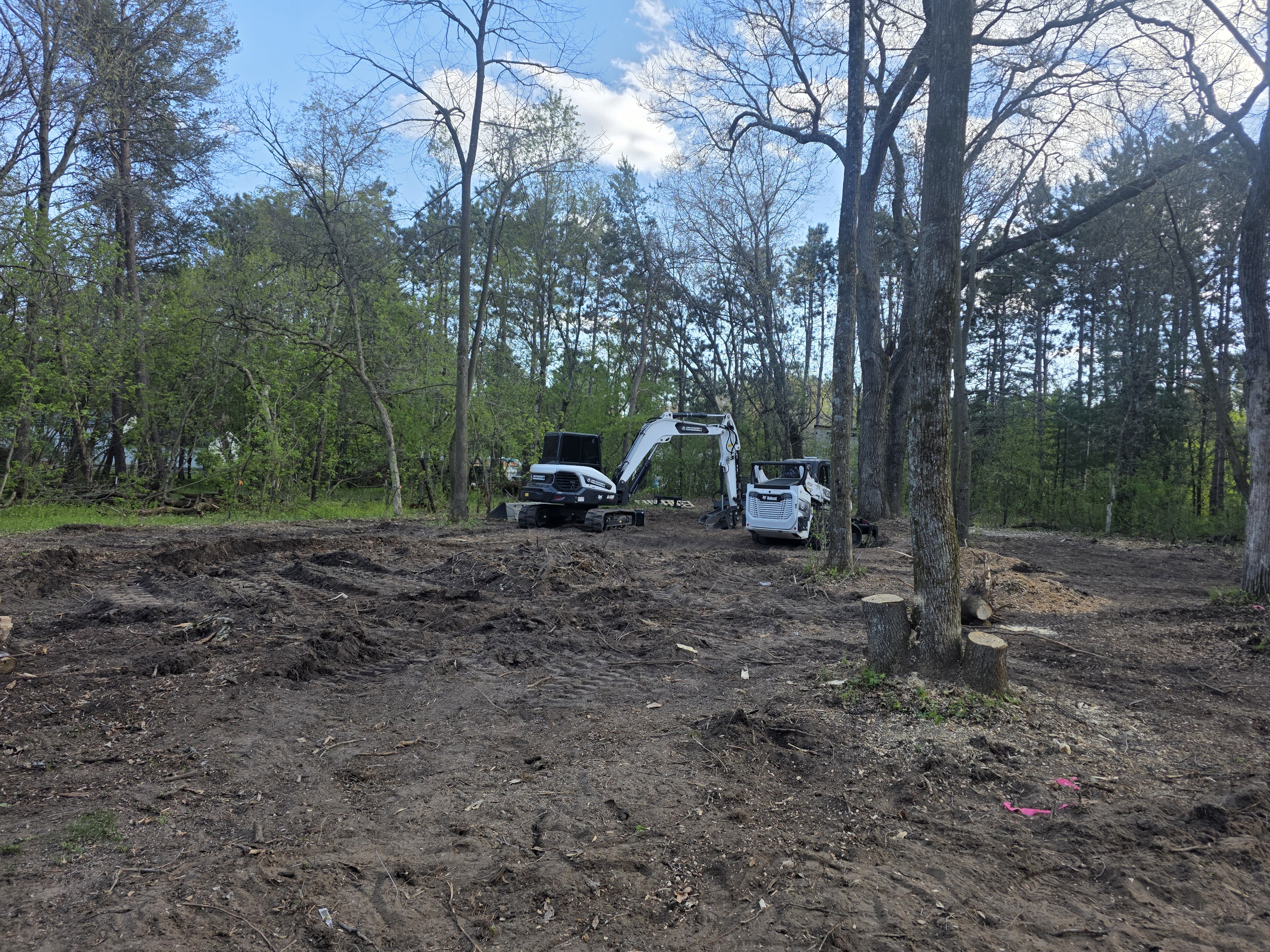 Heavy machinery clearing land for site preparation